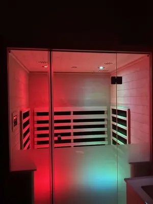 a room with red and blue lights on a glass door at Luxury cottage close to the beach in Løkken