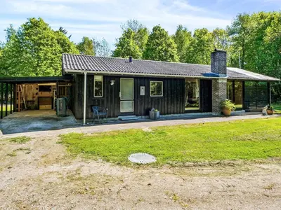 a small house with a porch and a yard at 6 person holiday home in Roslev in Roslev