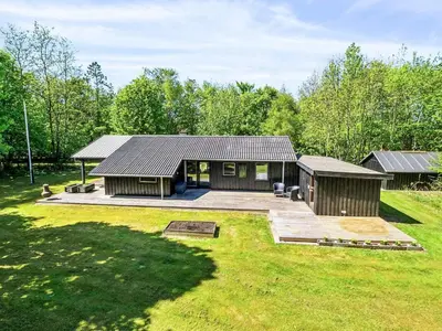 a home with a large yard with a house at 6 person holiday home in Roslev in Roslev