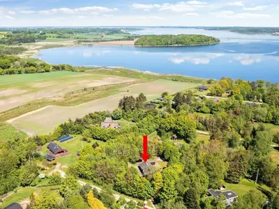 an aerial view of a house with a lake at 6 person holiday home in Roslev in Roslev