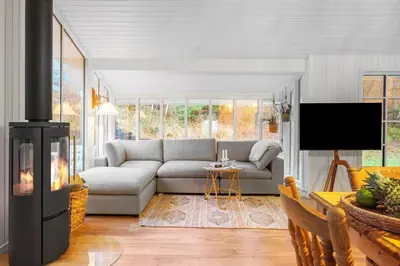 a living room with a couch and a fireplace at BL1148-Blokhus-Havorns-Alle-6 in Blokhus