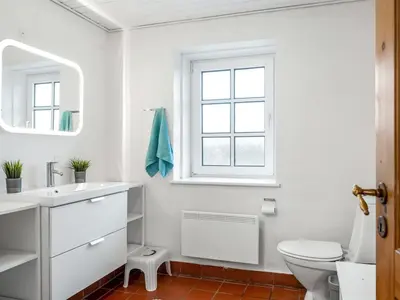 a white bathroom with a sink and a toilet at Holiday Home Siljana - 200m from the sea by Interhome in Lemvig