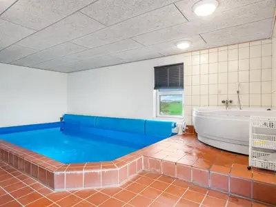 a large bathroom with a tub and a bath tub at Holiday Home Siljana - 200m from the sea by Interhome in Lemvig