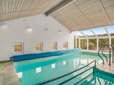 a large swimming pool with a large window at Holiday Home Nimrod - 70m from the sea by Interhome in Thisted