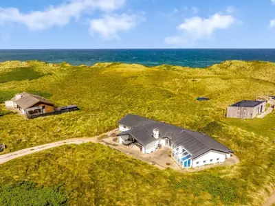 an aerial view of a house with the ocean in the background at Holiday Home Nimrod - 70m from the sea by Interhome in Thisted