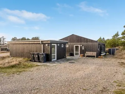 a house with a gravel driveway in front of it at Holiday Home Ovine - 900m from the sea by Interhome in Thisted
