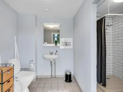 a white bathroom with a sink and a toilet at Holiday Home Borjana - 500m to the fjord by Interhome in Fur