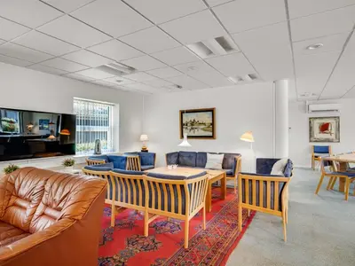 a living room with couches and a table and chairs at Holiday Home Borjana - 500m to the fjord by Interhome in Fur