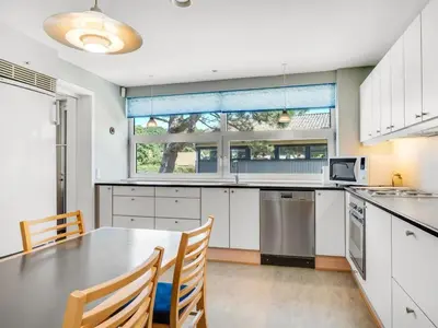 a kitchen with white cabinets and a table and chairs at Holiday Home Borjana - 500m to the fjord by Interhome in Fur