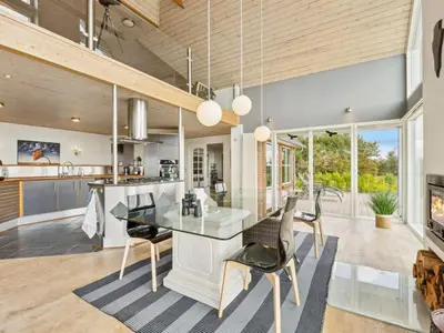 a kitchen and dining room with a table and chairs at Holiday Home Fridhild - 150m to the fjord by Interhome in Redsted