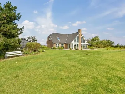 a house with a large yard with a bench at Holiday Home Fridhild - 150m to the fjord by Interhome in Redsted