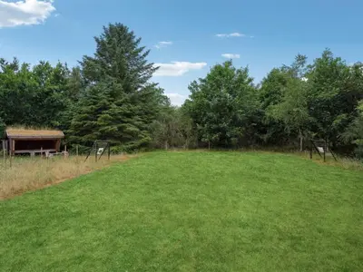 a large grass field with a gazebo and trees at Holiday Home Muriel - 1-6km from the sea by Interhome in Blokhus