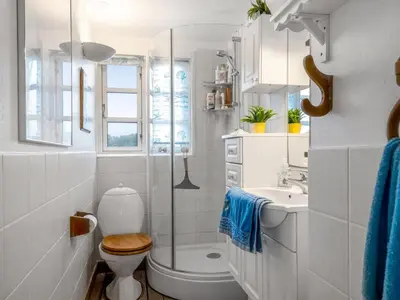 a white bathroom with a toilet and a sink at Holiday Home Åsta - 200m from the sea by Interhome in Saltum