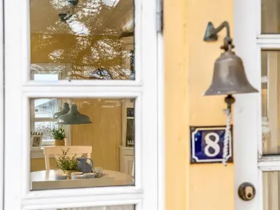 a bell in a window of a store at Holiday Home Åsta - 200m from the sea by Interhome in Saltum