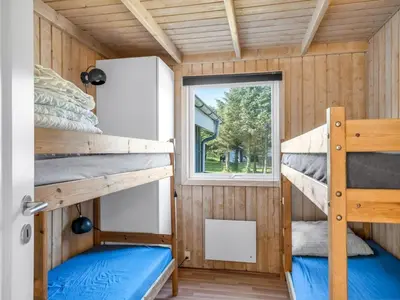 a bedroom with bunk beds in a tiny house at Holiday Home Peder - 700m from the sea by Interhome in Løkken