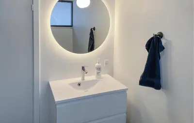 a white bathroom with a sink and a mirror at 3 Bedroom Stunning Home In Struer in Struer