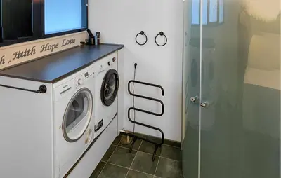 a laundry room with a washer and dryer at 3 Bedroom Stunning Home In Struer in Struer