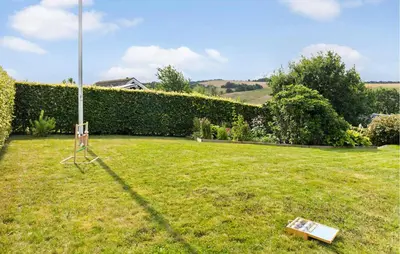 a yard with a sign in the grass at 2 Bedroom Cozy Home In Roslev in Roslev