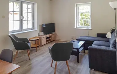 a living room with a couch and a tv at 4 Bedroom Beautiful Home In Farsø in Farsø