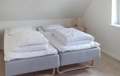 a bed with two pillows on top of it at 4 Bedroom Beautiful Home In Farsø in Farsø
