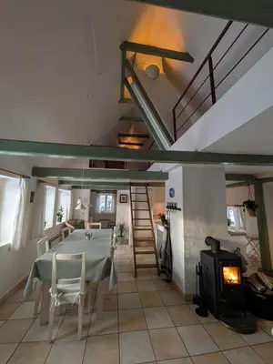 a dining room with a table and a fireplace at LF13177-Nykobing-Mors-Strandgaden-61 in Nykøbing Mors
