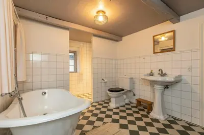 a bathroom with a tub and a toilet and a sink at Historic Ferry House By Limfjorden In Sillerslev in Øster Assels