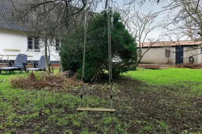 a swing in a yard in front of a house at Historic Ferry House By Limfjorden In Sillerslev in Øster Assels