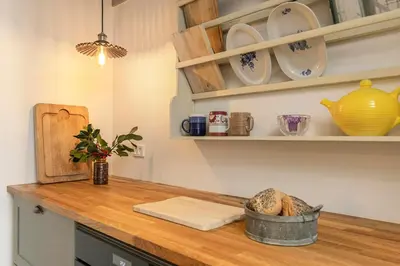 a kitchen counter with a basket of bread on it at Historic Ferry House By Limfjorden In Sillerslev in Øster Assels