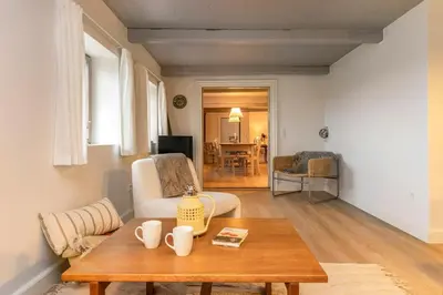 a living room with a coffee table and a couch at Historic Ferry House By Limfjorden In Sillerslev in Øster Assels
