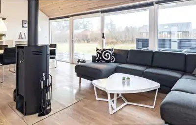 a living room with a couch and a table at 3 Bedroom Amazing Home In Brovst in Brovst