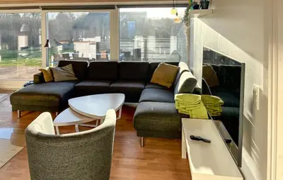 a living room with a couch and a table at 3 Bedroom Amazing Home In Brovst in Brovst