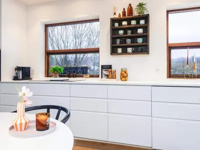 a kitchen with white cabinets and a table at 4 star holiday home in Viborg in Viborg