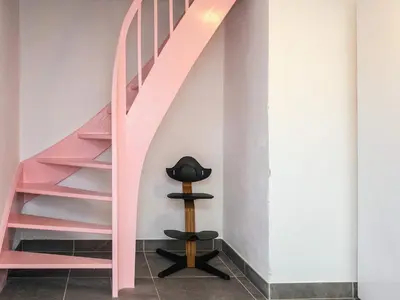 a pink staircase in a room with a hat on a stool at 4 star holiday home in Viborg in Viborg