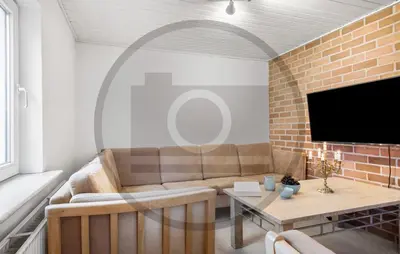 a living room with a couch and a table at 2 Bedroom Pet Friendly Home In Øster Assels in Øster Assels