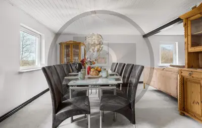 a dining room with a glass table and black chairs at 2 Bedroom Pet Friendly Home In Øster Assels in Øster Assels