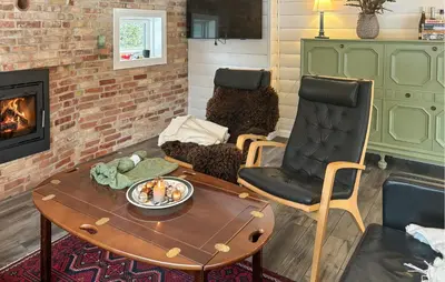 a living room with a chair and a coffee table at Stunning Home In Løgstør With Sauna in Løgstør