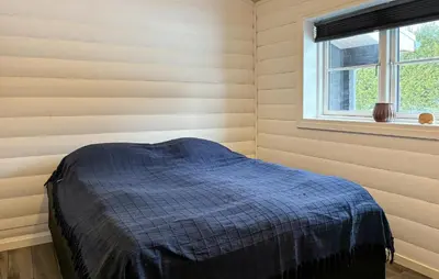 a bed in a room with a window at Stunning Home In Løgstør With Sauna in Løgstør