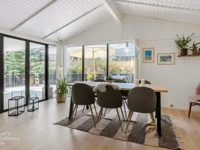 a dining room with a table and chairs at 4 star holiday home in Blokhus in Blokhus