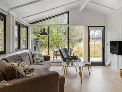 a living room with a couch and a table at 4 star holiday home in Blokhus in Blokhus