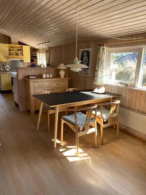 a kitchen with a table and chairs in a room at Peaceful Base Near Beach And Nature in Saltum