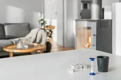 a living room with a fireplace and a table at JB405-Brovst-Kronvildtvej-37 in Tranum Strand