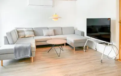 a living room with a couch and a tv at Cozy Home In Nykøbing M With Wifi in Tæbring