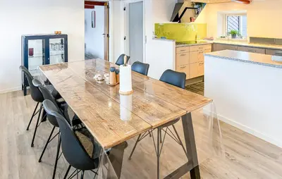 a kitchen with a wooden table and chairs at Cozy Home In Nykøbing M With Wifi in Tæbring