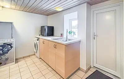 a kitchen with a sink and a microwave at Cozy Home In Nykøbing M With Wifi in Tæbring