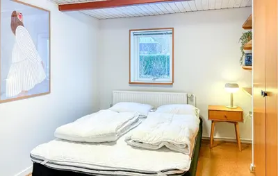 a bedroom with a bed with white sheets and a window at Cozy Home In Nykøbing M With Wifi in Tæbring