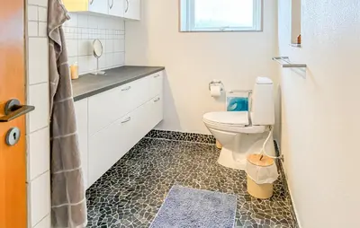 a bathroom with a toilet and a sink at Cozy Home In Nykøbing M With Wifi in Tæbring