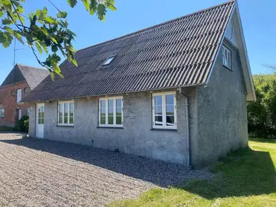 a stone house with a gambrel roof at Feddet, Jørgen's Feriehus in Lemvig