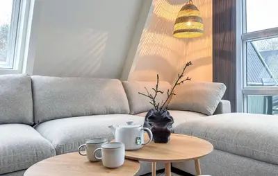 a living room with a couch and a table with mugs on it at Awesome Home In Farsø With Wifi in Farsø