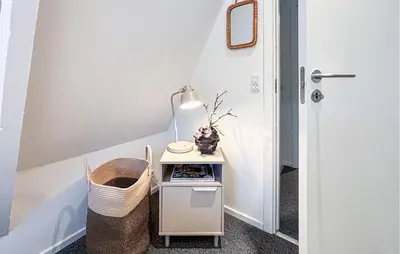 a small table with a lamp on it in a room at Awesome Home In Farsø With Wifi in Farsø