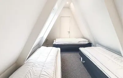 two beds in a room with white walls at Awesome Home In Farsø With Wifi in Farsø